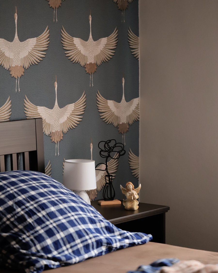 Bedroom accent wall in a crane-motif chinoiserie wallpaper